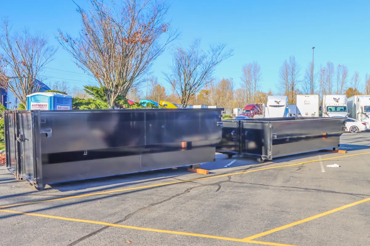 Professional dumpster rental service with roll-off container on residential driveway in Barnesville